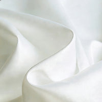 A close-up of Longan Craft Matte Satin Fabric by the Yard shows its smooth, solid color surface with gentle folds and soft shadows—an elegant, comfortable textile ideal for bridesmaid dresses.
