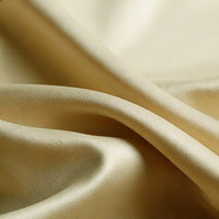 Close-up of Longan Craft Matte Satin Fabric By The Yard in beige, featuring a soft satin texture with gentle folds and a subtle sheen—comfortable and ideal for solid color bridesmaid dresses.