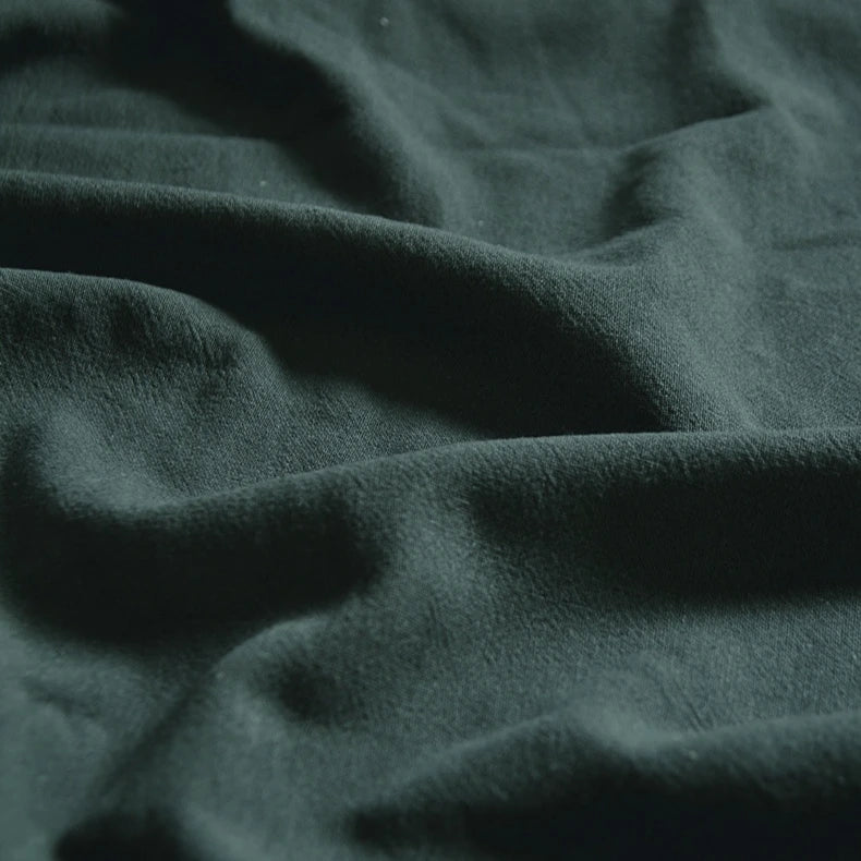 Close-up of Medium Weight Viscose Linen Fabric by Longan Craft, featuring a washed finish and soft texture with gentle folds and natural shadows. Ideal breathable material for clothing, sold by the yard in multicolor options.