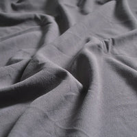 A close-up of Longan Craft’s Medium Weight Viscose Linen Fabric by the yard shows soft, multicolor material with a washed, crinkle texture and gentle folds—ideal breathable viscose clothing fabric.