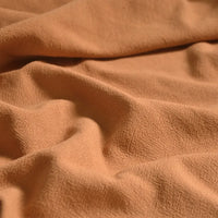 A close-up of Longan Craft’s Medium Weight Viscose Linen Fabric by the Yard features a softly textured, multicolor washed finish and natural folds, showcasing its breathable quality—ideal for comfortable clothing material.
