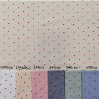 Mini Red Dot Printed Pointelle Fabric By The Yard in a mini red dot pointelle knit, shown in white, apricot, pink, grey, green, and blue swatches.
