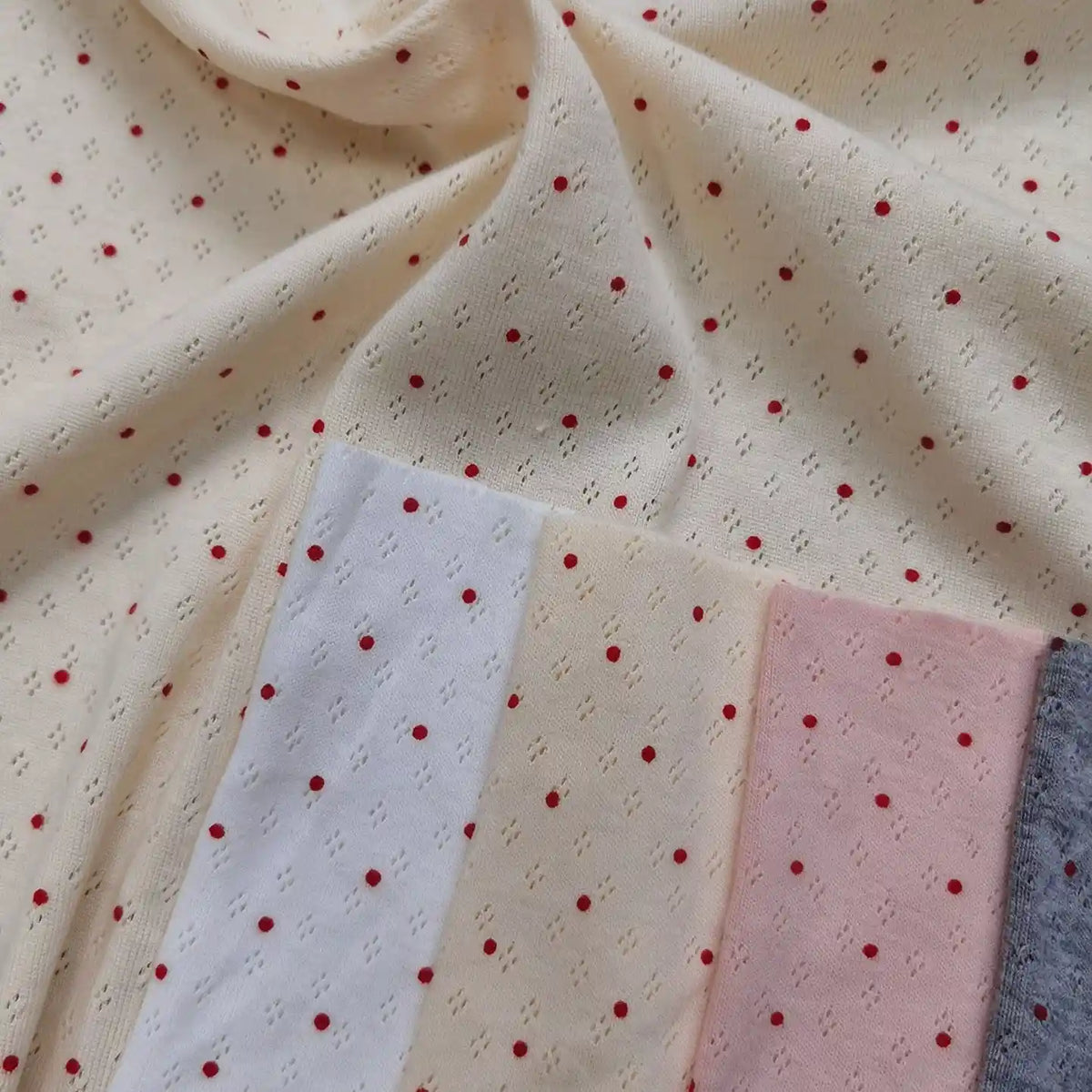 Mini Red Dot Printed Pointelle Fabric By The Yard in cream with a red mini dot pattern, shown with white, light pink, and grey cotton jersey color swatches.