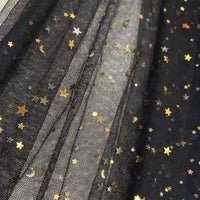 Close-up of Longan Craft's Moon Star Sequins Tulle Fabric By The Yard, multicolor glitter tulle material with gold and silver star and moon details—shimmery pleated layers perfect for stage costumes or evening gowns.