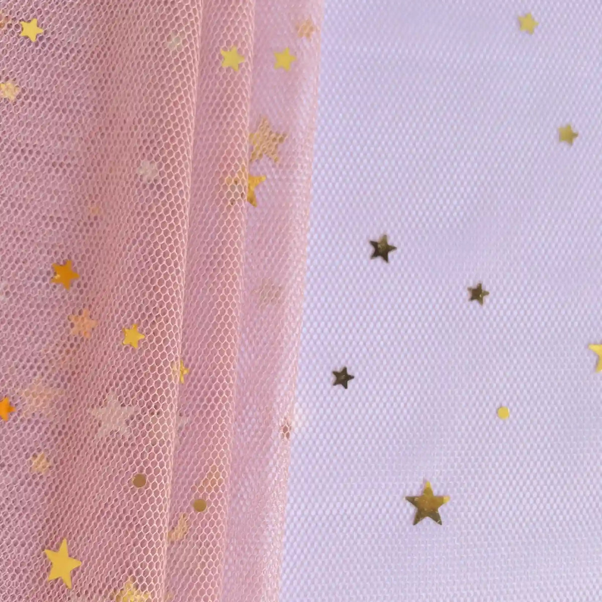 Moon Star Sequins Tulle Fabric by the yard from Longan Craft features multicolor glitter, pink mesh, and gold star confetti—perfect for stage costumes. Gold stars accent a white textured surface for a dazzling look.
