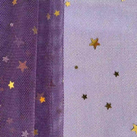 A close-up of Longan Craft’s Moon Star Sequins Tulle Fabric shows purple and white mesh with gold star sequins—perfect for stage costumes or statement designs. This multicolor glitter tulle creates a whimsical, starry effect.