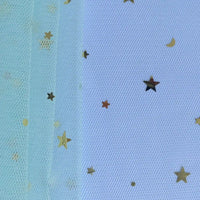 Close-up of Longan Craft's Moon Star Sequins Tulle Fabric by the yard in light blue, with gold star and moon confetti—ideal for stage costumes or dancewear. Background texture shows through this multicolor glitter tulle material.