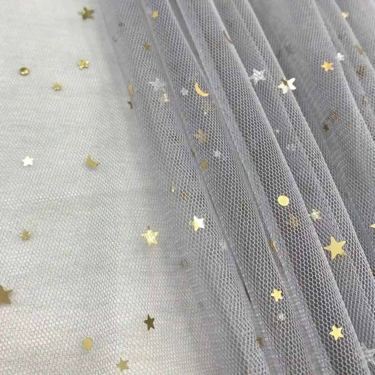 Longan Craft’s Moon Star Sequins Tulle Fabric features multicolor glitter stars and moons on sheer tulle, perfect for standout stage costumes or dancewear. Sold by the yard, this fabric adds a delicate, celestial shimmer to any project.