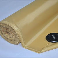A roll of Longan Craft Multicolor 300D Oxford Fabric by the yard, PU coated polyester, partially unrolled on a white surface with a black Nikon lens cap resting on the durable material for bags and backpacks.