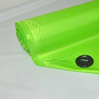 A roll of bright green Longan Craft Multicolor 300D Oxford PU coated polyester fabric, partially unrolled on a light surface, displays a black snap detail near the edge—ideal durable material for bags and backpacks.