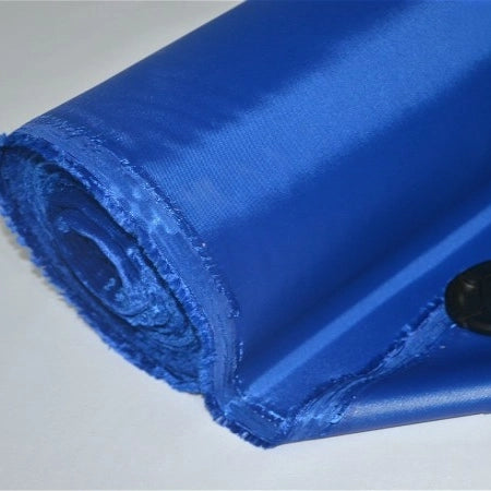 A close-up of Longan Craft's Multicolor 300D Oxford Fabric, a shiny blue PU-coated polyester material with unfinished edges, partially unrolled on a white surface—perfect for bags and backpacks.