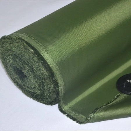 A close-up of Multicolor 300D Oxford Fabric by the yard from Longan Craft, a shiny olive green PU coated polyester, rests on a white surface with a small black button atop the water repellent material for bags and backpacks.