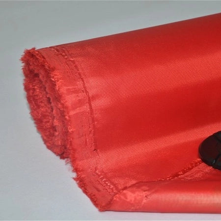 A partially unrolled piece of Longan Craft Multicolor 300D Oxford Fabric with a PU coating is shown on a white surface, highlighting its durable polyester material ideal for bags and backpacks.