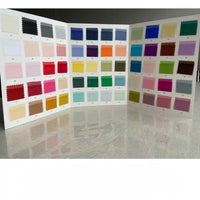 A trifold display board showcases numbered swatches of Longan Craft's Multicolor 8 Momme Organza Pure Mulberry Silk Fabric, neatly arranged in a colorful grid on a reflective surface.