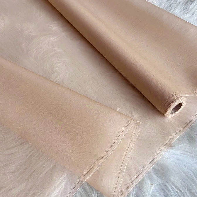A yard of Longan Craft’s Multicolor 8 Momme Organza Silk—pure mulberry silk fabric—is displayed on a white surface, revealing its sheer and luxurious texture, perfect for elegant dresses and premium crafting.