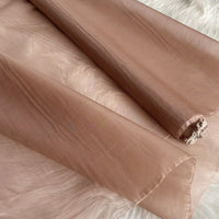 A yard of Multicolor 8 Momme Organza Silk Fabric by Longan Craft—pure mulberry silk perfect for luxurious dresses—rests on a soft white furry surface, displaying its smooth, delicate texture and elegant sheen.