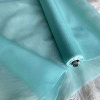 A close-up of Longan Craft's Multicolor 8 Momme Organza Silk Fabric By The Yard, made from pure mulberry silk, shows its smooth, translucent texture—perfect for airy evening gowns and luxury dresses.