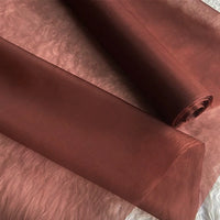 Two rolls of Multicolor 8 Momme Organza Silk Fabric by Longan Craft, made from pure mulberry silk, are displayed on a flat surface, showcasing their smooth, translucent texture and luxurious sheen—perfect for elegant dresses.