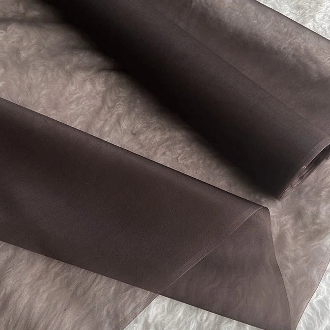 A close-up of Longan Craft's Multicolor 8 Momme Organza Silk Fabric by the yard, made from pure mulberry silk. The luxurious fabric is sheer, lightweight, and slightly translucent—ideal for elegant dresses.