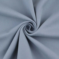 Close-up of Longan Craft Multicolor Cotton Bamboo Blend Lyocell Fabric by the yard, twisted to showcase its soft, fine diagonal twill lines and wrinkle-free texture—ideal lyocell textile for DIY pants.