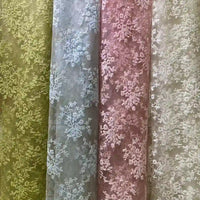 Four rolls of Longan Craft Multicolor Embroidered Floral Tulle Fabric are shown in pastel green, blue, pink, and beige—each with intricate cotton thread embroidery—ideal for wedding lace or elegant projects.