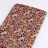 Longan Craft Multicolor Fine Cotton Printed Lawn Fabric by the yard features a lightweight floral print with small red, orange, and white flowers on a light background—ideal for summer lawn clothing.
