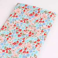 Longan Craft's Multicolor Fine Cotton Printed Lawn Fabric features a lightweight floral print with red, blue, and pink flowers on a light background—perfect for lawn clothing projects. Sold by the yard, neatly folded for your convenience.