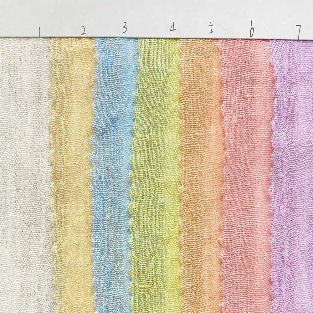 Seven vertical pastel stripes crafted from Longan Craft’s Multicolor Heathered Crepe Fabric By The Yard—made of 100% linen sandwashed crepe—appear in white, yellow, blue, green, orange, pink, and purple. Each stripe is numbered from 1 to 7 along the top edge on a ruler-like white strip.