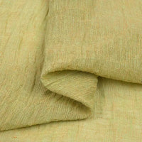 A close-up view of the Multicolor Heathered Crepe Fabric by Longan Craft, featuring light yellow tones, a textured sandwashed linen crepe surface, visible woven fibers, and a soft, natural fold in this durable material—perfect for apparel.