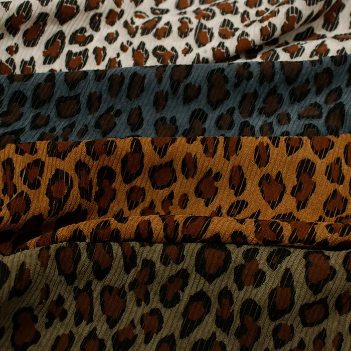 Four rows of Longan Craft Multicolor Leopard Printed Corduroy Fabric display bold black and brown animal prints in cream, gray-blue, orange-brown, and olive green on soft polyester corduroy—perfect for unique apparel projects.