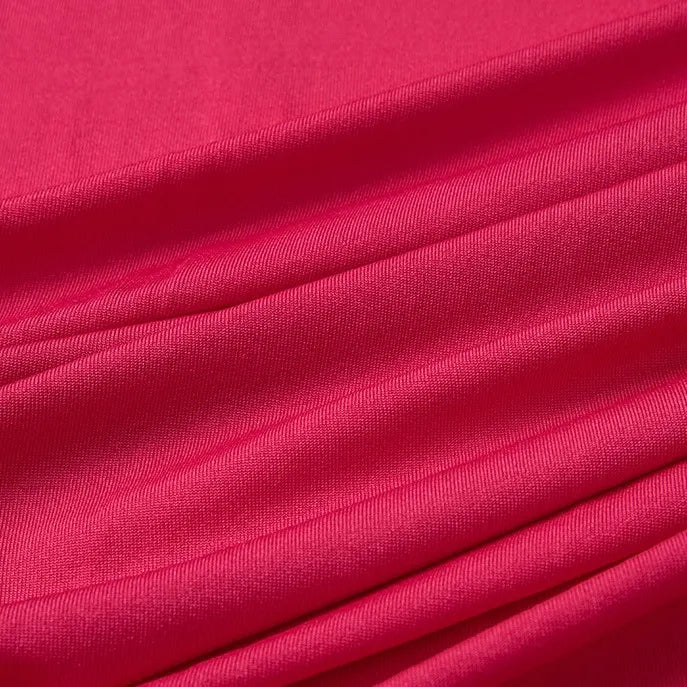 Close-up of Longan Craft's Multicolor Polyester Jersey Fabric By The Yard, a stretchable elastane jersey with bright pink, wrinkle-resistant texture and soft diagonal folds—ideal for dresses and crafts.