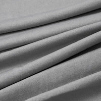 Close-up of Longan Craft Multicolor Polyester Jersey Fabric by the Yard, a stretchable elastane jersey dress fabric in light gray. The smooth, breathable material features soft folds and subtle parallel diagonal lines for gentle draping.