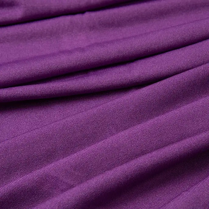Close-up of Longan Craft's Multicolor Polyester Jersey Fabric By The Yard, a stretchable elastane jersey dress fabric in purple, highlighting its textured surface with gentle folds, diagonal lines, and soft shadows.