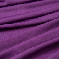 Close-up of Longan Craft's Multicolor Polyester Jersey Fabric By The Yard, a stretchable elastane jersey dress fabric in purple, highlighting its textured surface with gentle folds, diagonal lines, and soft shadows.