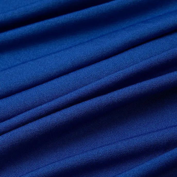 Close-up of Longan Craft's Multicolor Polyester Jersey Fabric by the Yard, showing its stretchable elastane weave in blue with soft diagonal folds and visible texture, ideal for jersey dressmaking.