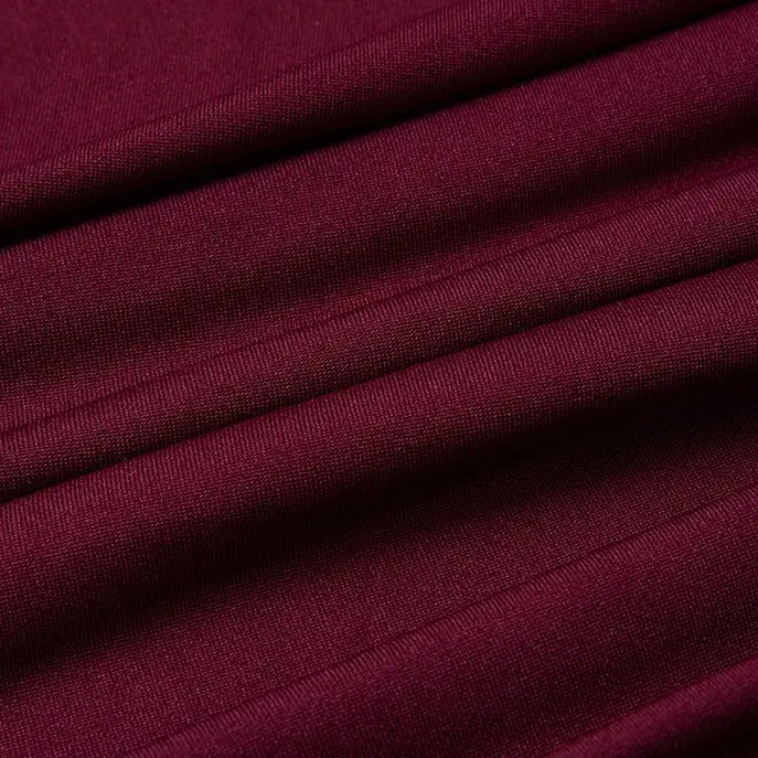 Close-up of Longan Craft Multicolor Polyester Jersey Fabric By The Yard shows smooth, wrinkle-resistant texture with neat creases; this stretchable elastane jersey fabric is ideal for dresses and apparel projects.
