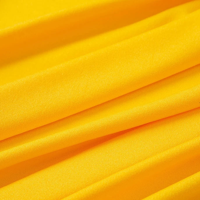 Bright multicolor polyester jersey fabric by the yard from Longan Craft, featuring stretchable elastane. The smooth material has soft, diagonal folds for a textured effect and reflects light to highlight the contours—ideal for dresses.