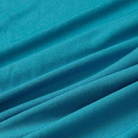 Close-up of Longan Craft Multicolor Polyester Jersey Fabric By The Yard, showing its wrinkle-resistant, stretchable elastane texture in turquoise blue with soft folds and gentle diagonal lines.