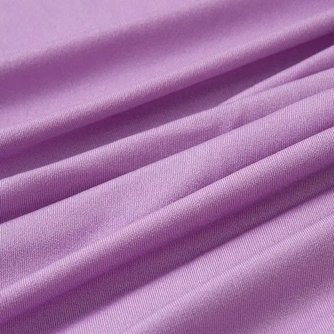 A close-up of Longan Craft's Multicolor Polyester Jersey Fabric by the yard, showing its light purple, stretchable elastane jersey material with soft diagonal folds and a smooth, slightly textured surface.