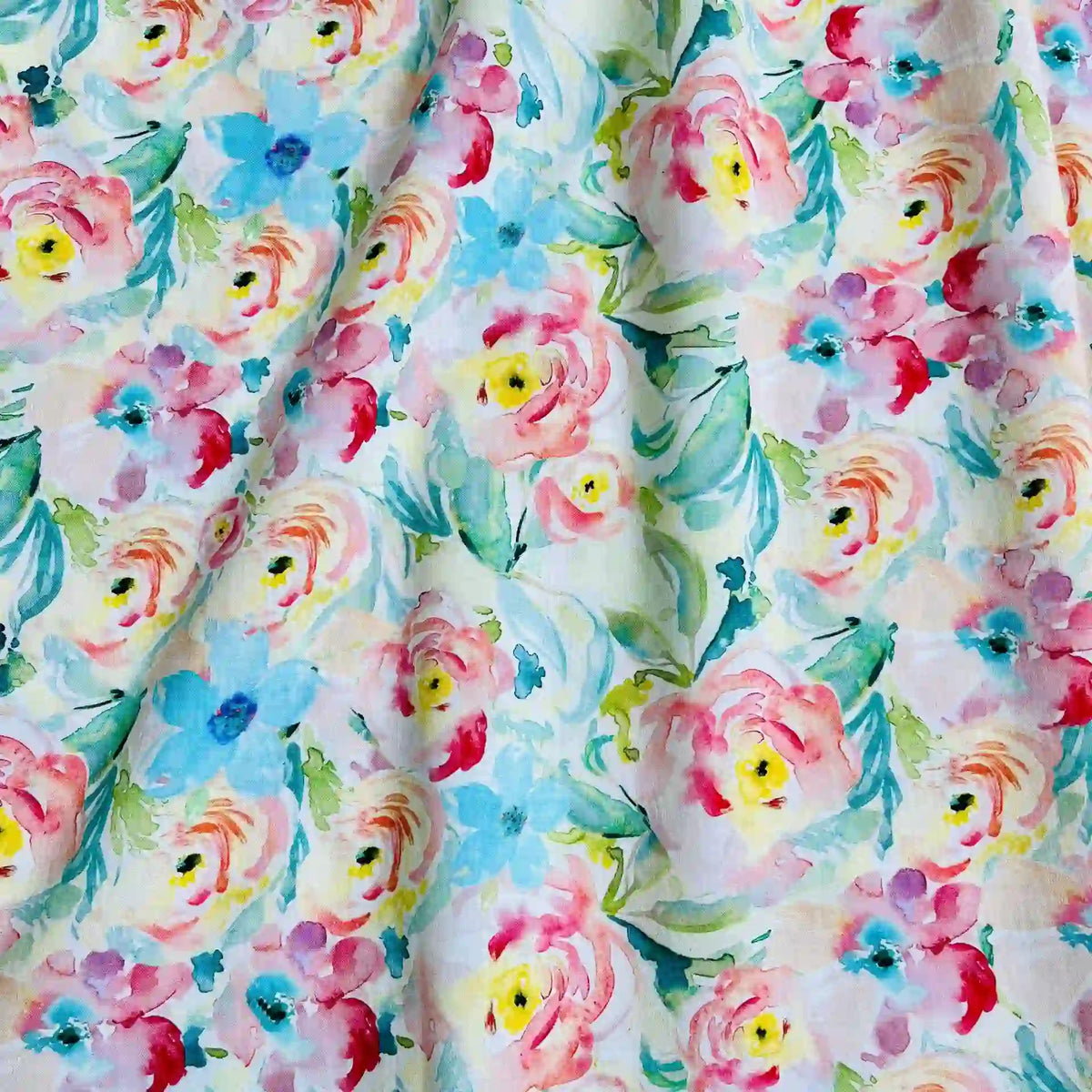Longan Craft's Multicolor Printed Lawn Fabric by the Yard features a watercolor-style floral design in pink, yellow, and blue with green leaves on white pure cotton; the soft, slightly wrinkled lawn adds subtle shadows and texture.