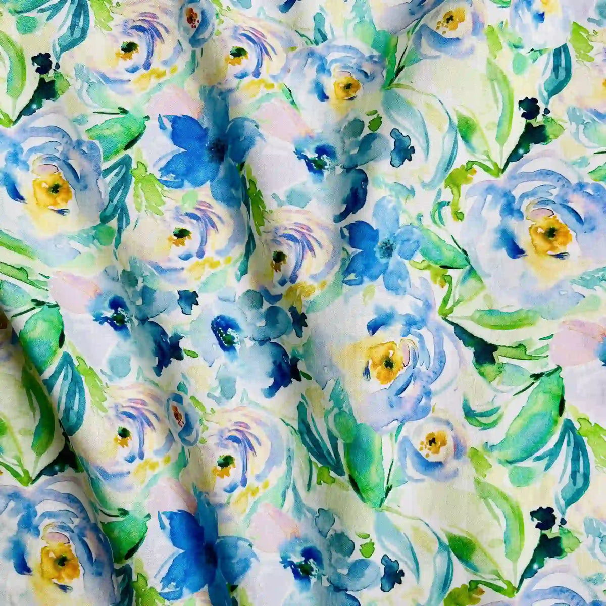 The Multicolor Printed Lawn Fabric by Longan Craft features a soft, watercolor floral design with blue, yellow, and green flowers on white pure cotton—a painterly look perfect for crafts and garments.