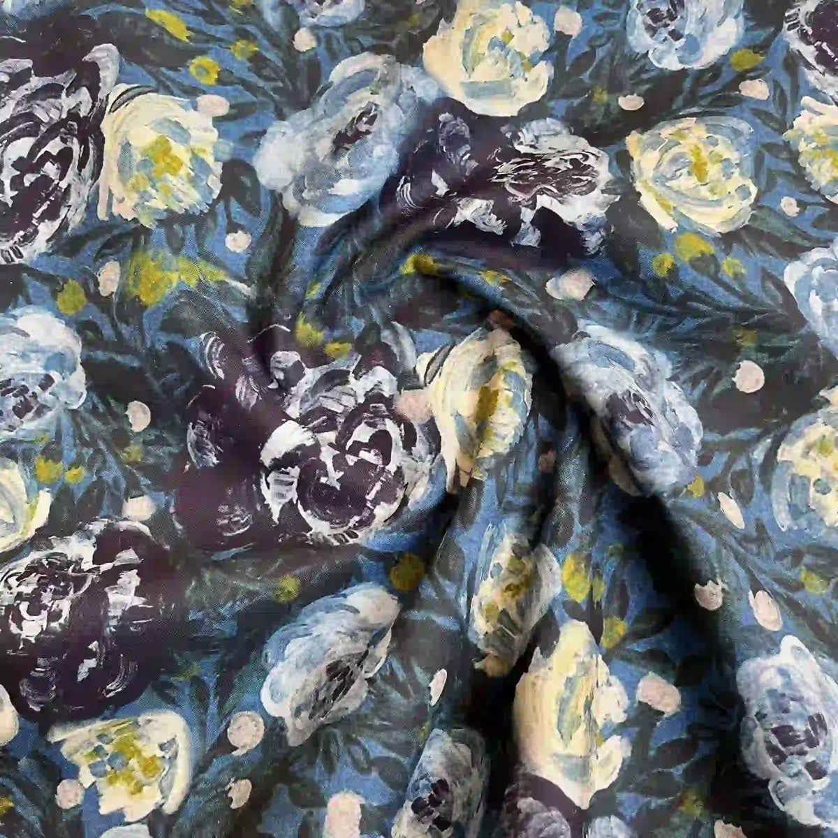 Close-up of Longan Craft's Multicolor Printed Lawn Fabric by the yard, featuring a floral cotton lawn material with watercolor-style blue, white, yellow, and green flowers on a dark background—soft and eye-catching.