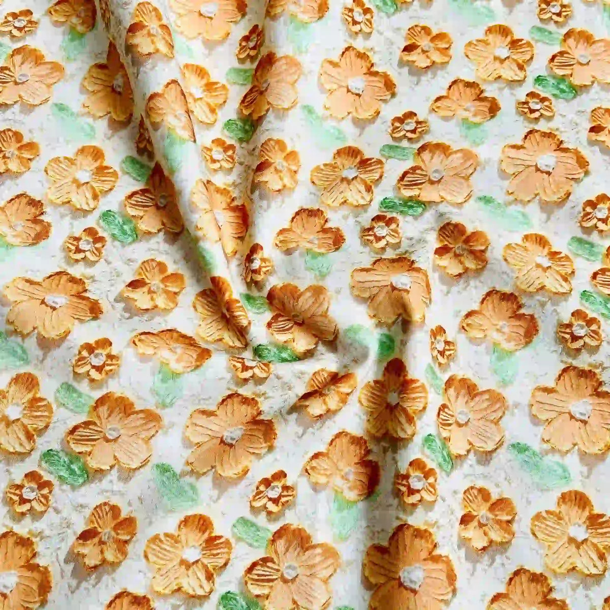 Longan Craft's Multicolor Printed Lawn Fabric by the Yard features soft pure cotton with large orange and yellow floral prints and green leaves on a white background. Visible folds and creases add subtle texture to this soft floral lawn material.