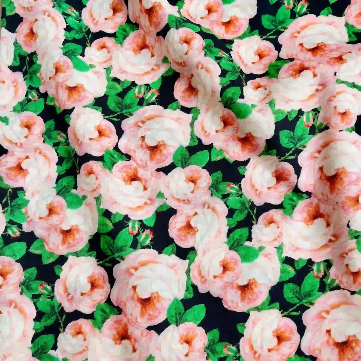 Longan Craft’s Multicolor Printed Lawn Fabric By The Yard features soft cotton with light pink roses and green leaves on a dark base—a vibrant floral print ideal for standout clothing or décor.