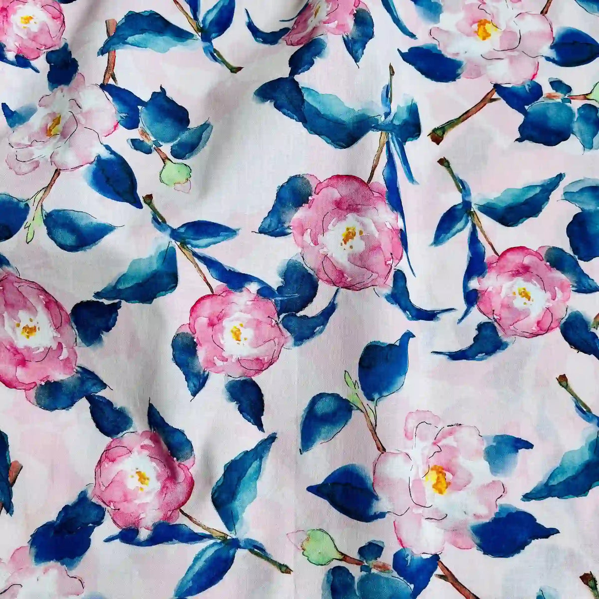 Longan Craft’s Multicolor Printed Lawn Fabric features a soft floral cotton pattern with pink flowers, yellow centers, and blue-green leaves—perfect for floral fabric lovers and ideal for artistic sewing projects.