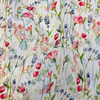 The Multicolor Printed Lawn Fabric by Longan Craft features a watercolor-style floral design with pink, red, purple, and blue wildflowers on white lawn cotton. Perfect by the yard for projects needing soft, colorful floral cotton fabric.