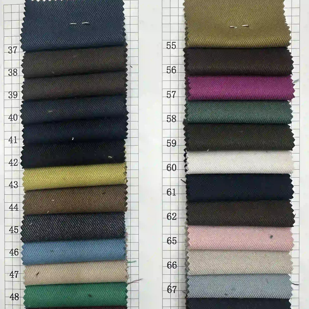 Multicolor rayon gabardine fabric swatches from Longan Craft are arranged in two vertical columns labeled 37–48 and 55–67, showcasing dark, bright, and pastel wrinkle-resistant options. Available by the yard for custom uniforms.