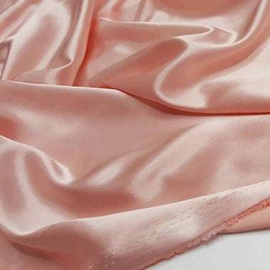 A close-up of Longan Craft Multicolor Satin Fabric by the Yard shows its silky polyester surface and soft folds, highlighting a luxurious appearance—perfect for apparel and textile projects.