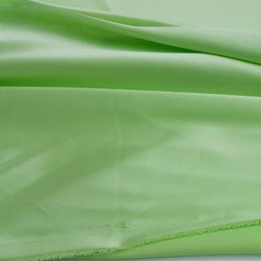 A close-up of silky, multicolor polyester satin fabric by Longan Craft, showcasing its soft sheen and gentle drape—ideal for apparel and available by the yard.