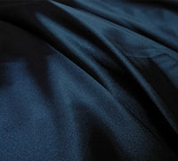 A close-up of Longan Craft's Multicolor Satin Fabric by the yard shows its silky polyester texture, subtle sheen, and gentle folds—an ideal textile for apparel.